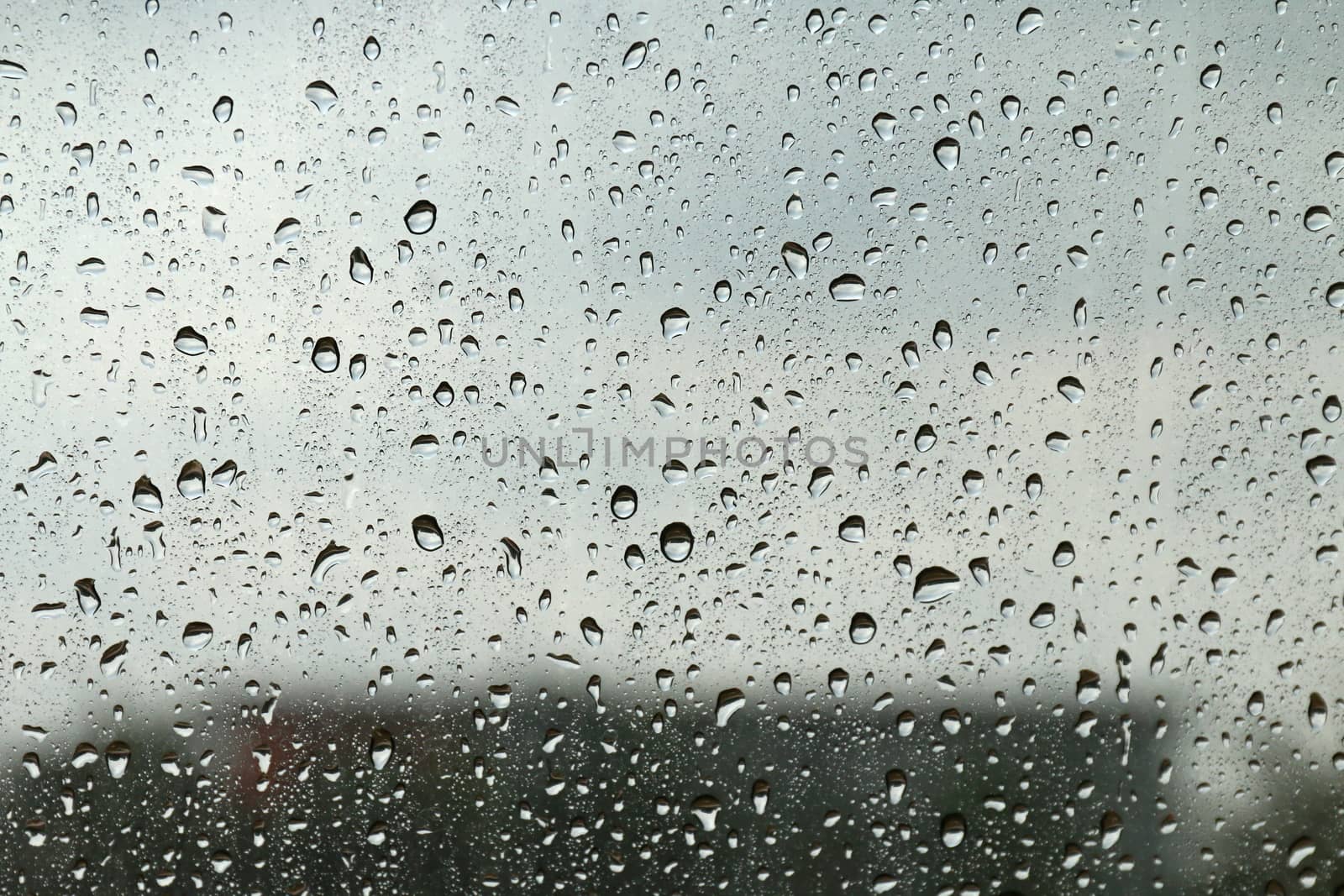 Water drop fresh condensation on window glass texture, rainy season wet background cooling feels and cold, raindrops texture wet transparent bubble