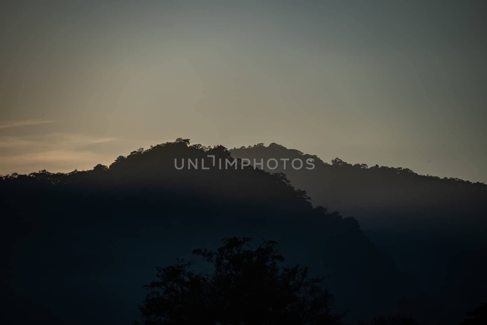 Mountain landscape with flare of the sun rise.