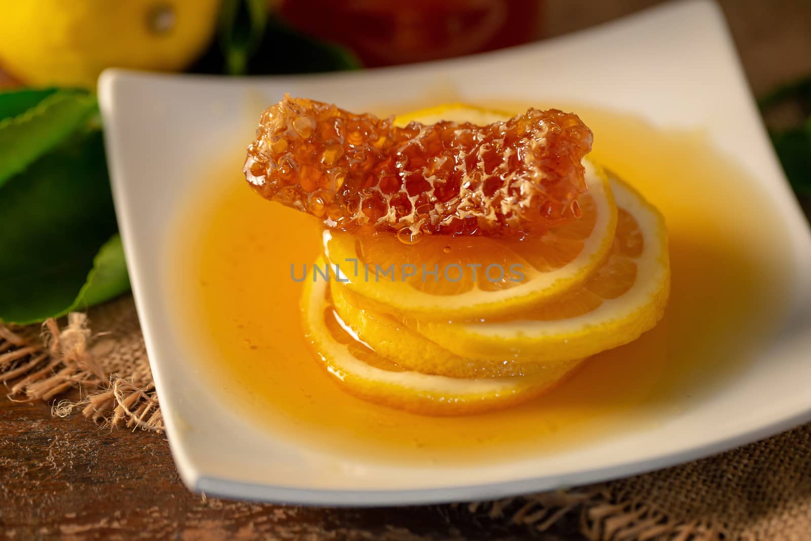 Lemon juice with honey on wooden table,  lemons and sage leaves by kaiskynet