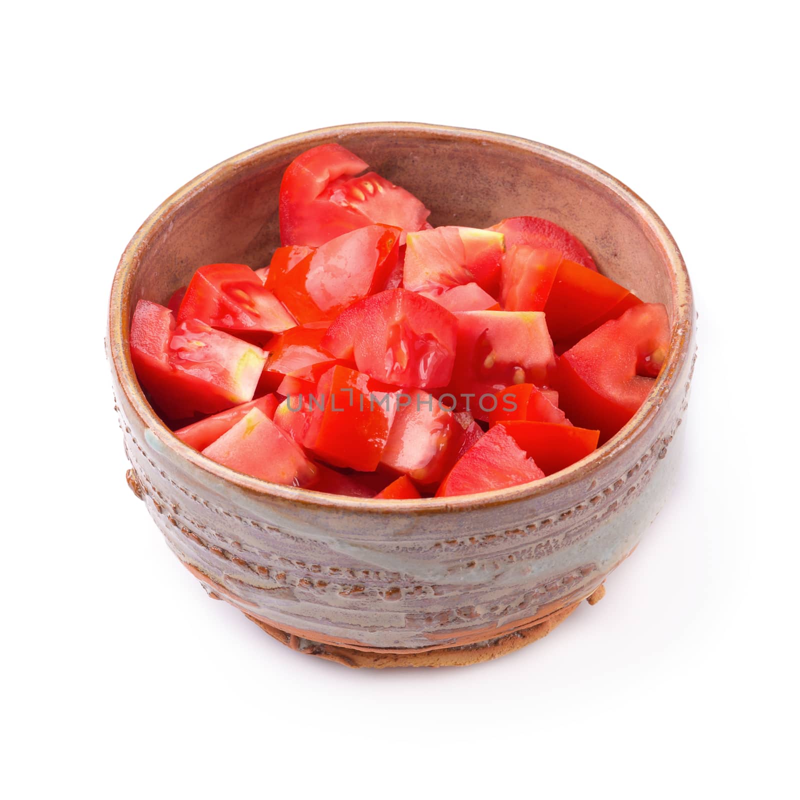 Chopped tomatoes in a bowl isolated on a white background by kaiskynet