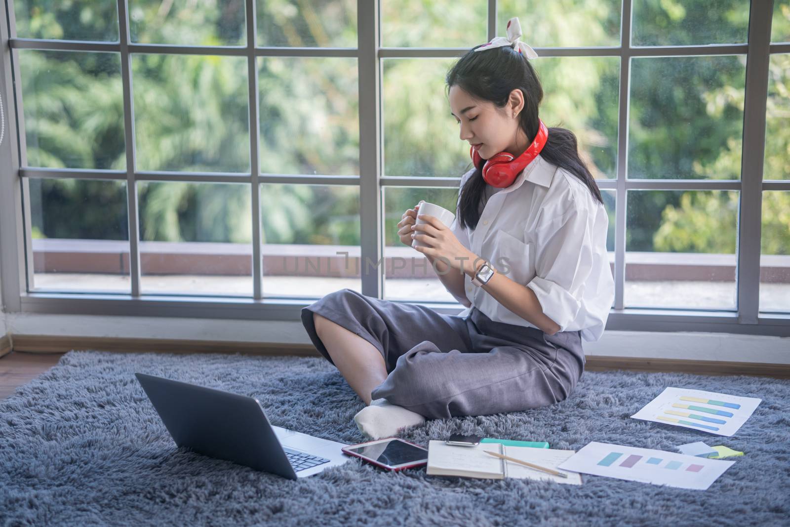 top view of young asian woman working with laptop computer in th by sandyman