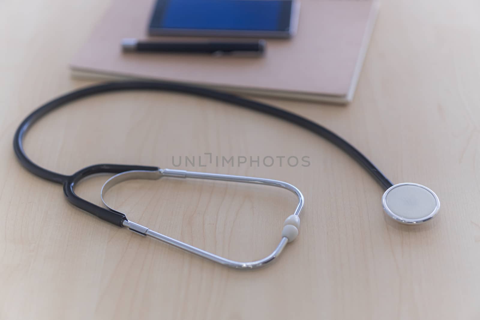 Black stethoscope on white table. Healthcare.