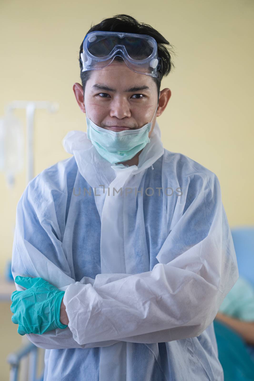 Smiling asian male doctor removing his surgical mask after work  by sandyman