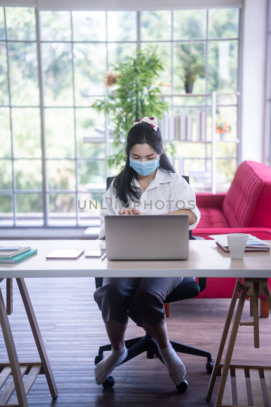 top view of young asian woman working with laptop computer in th by sandyman