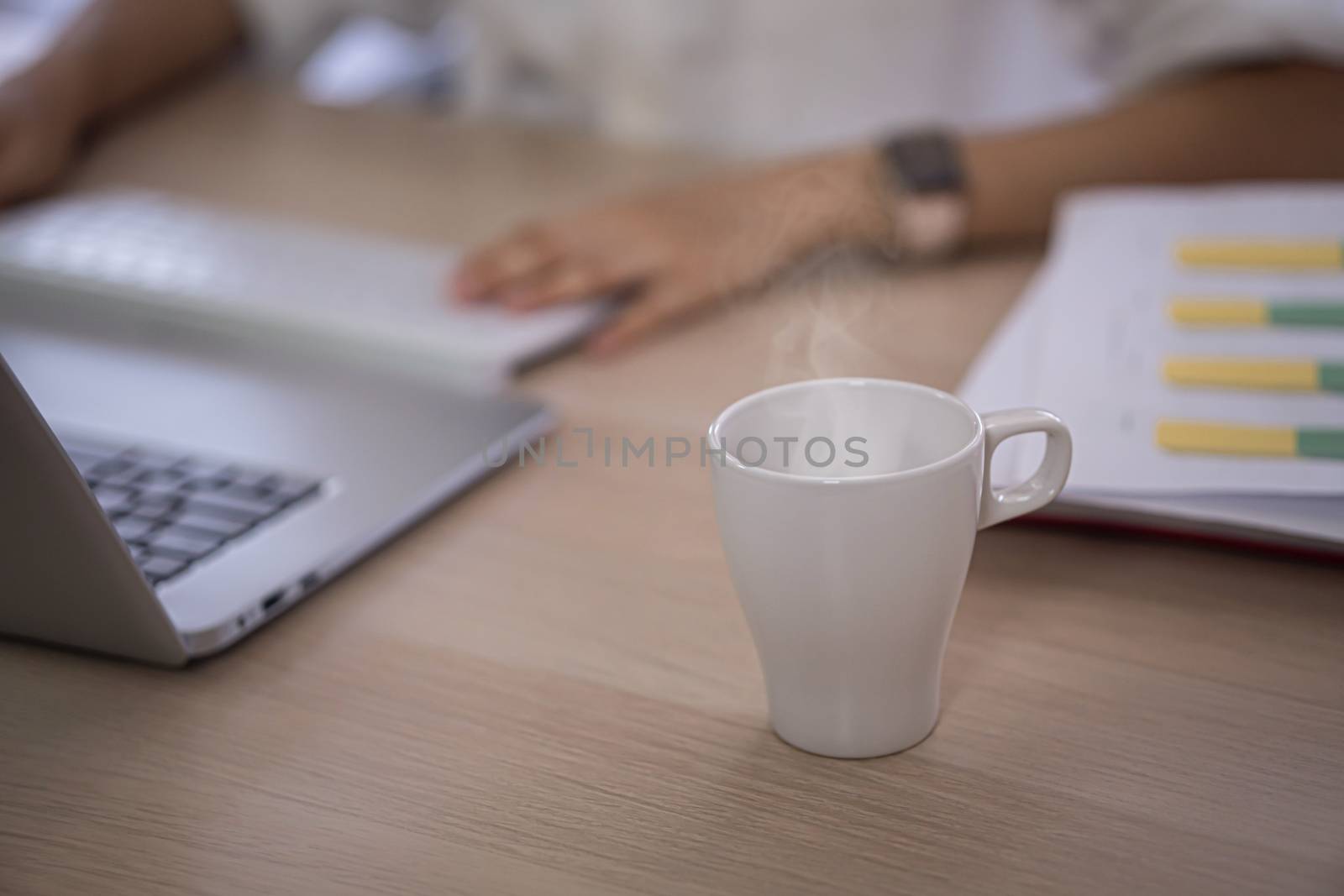 hot coffee cup on computer table by sandyman