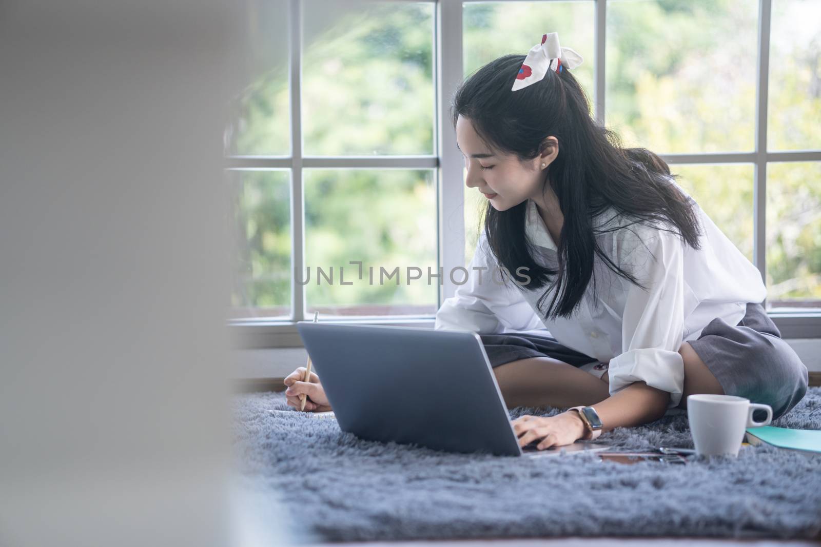 top view of young asian woman working with laptop computer in th by sandyman