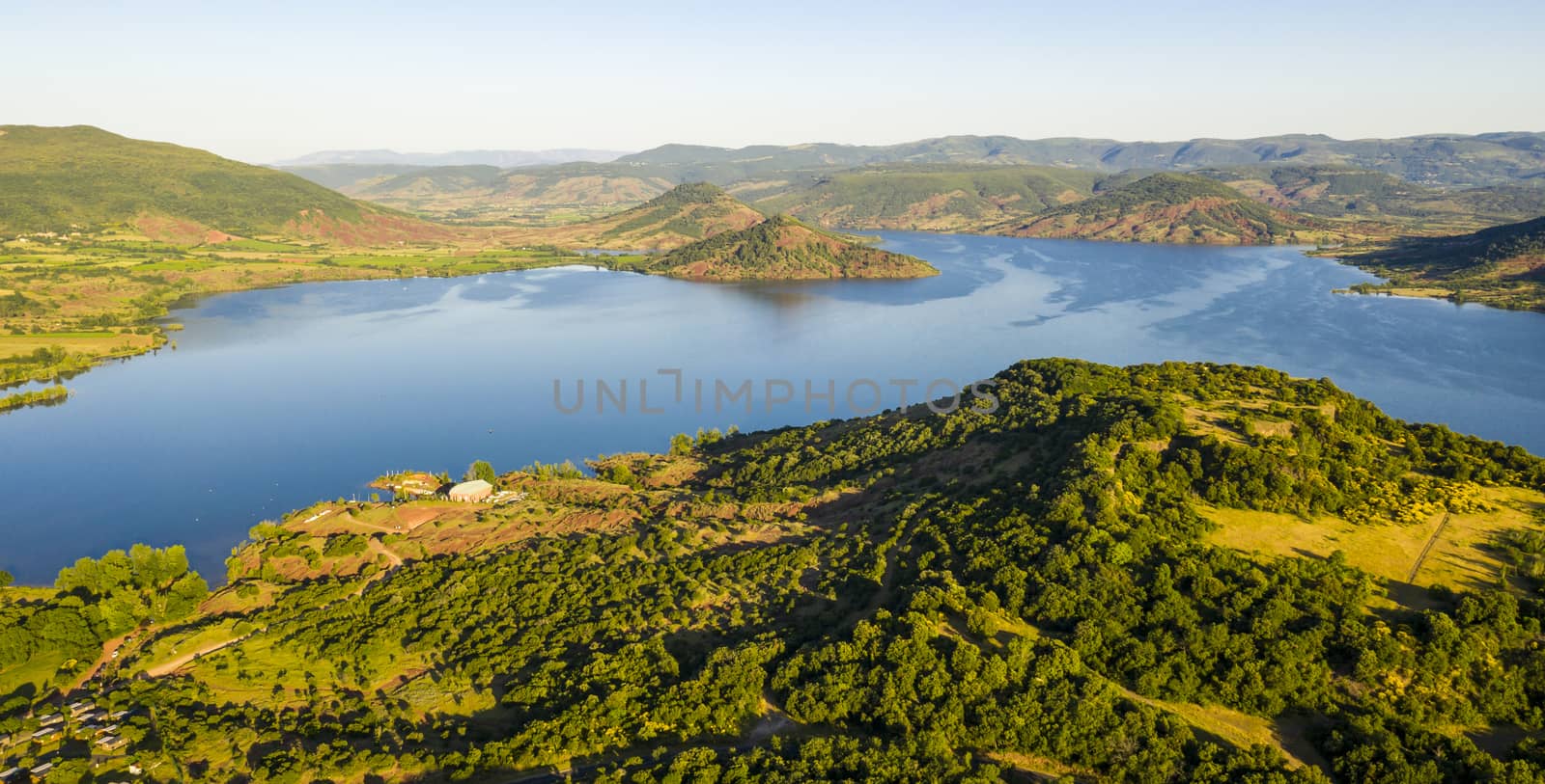 Aerial panorama of Lac du Salagou in the early morning in summer in Hérault in Occitania, France by Frederic
