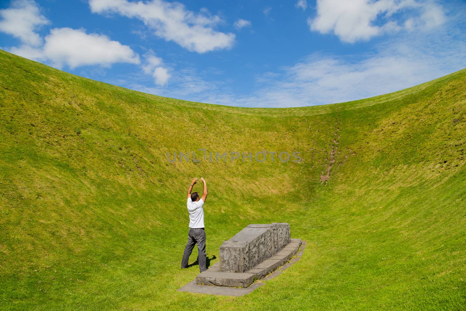 Man with open arms at the the Irish Sky Garden Crater, Skibbereen, West Cork. Ireland