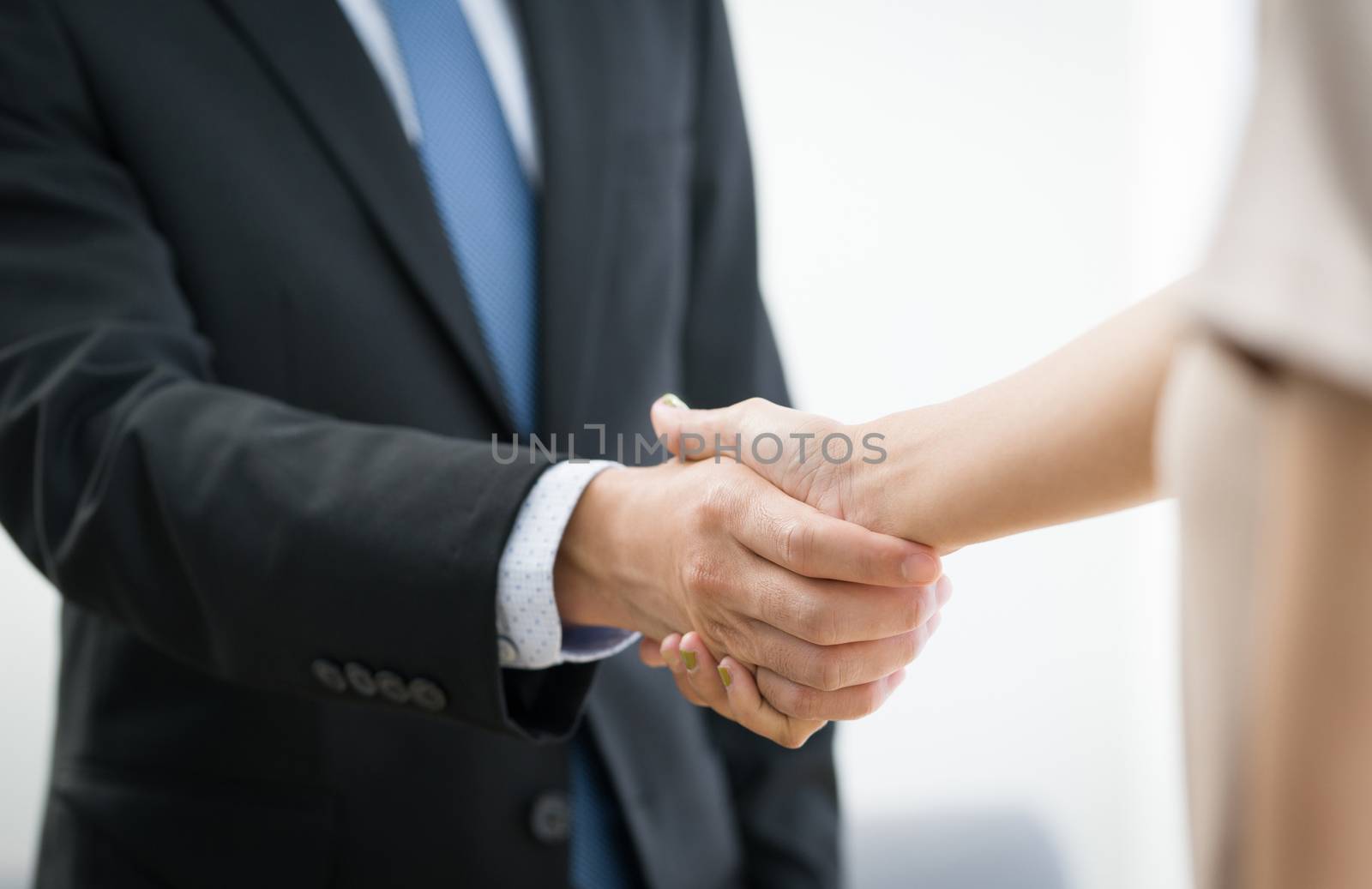 Business partners shaking hands in the modern office by chadchai_k