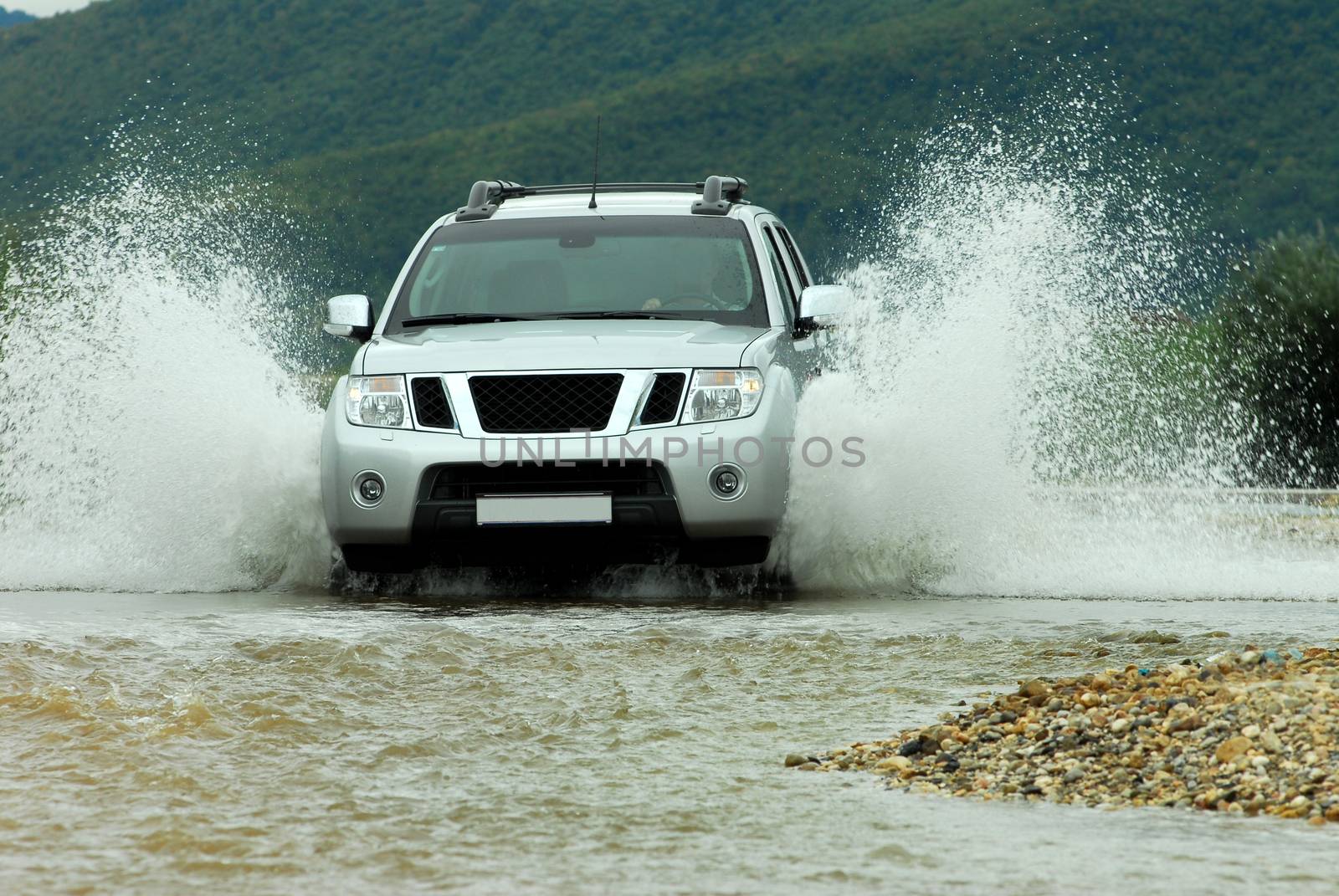 Suv splash on the river outdoor, traveling on the road