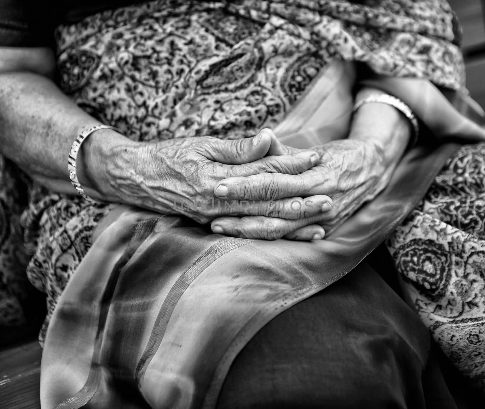 Wrinkled hands of Indian woman, dressed in traditional sari