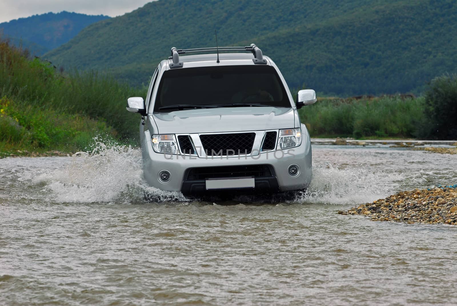 Suv splash on the river outdoor, traveling on the road