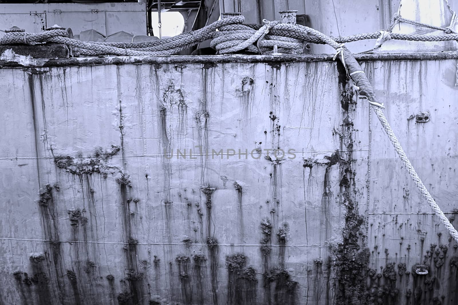 Monochrome image of old ship hull and ropes
