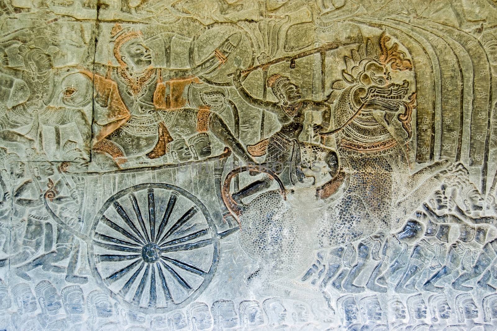 The Hindu god Vishnu on a chariot pulled by an imperial lion going in battle with the demons, or asuras. Ancient Khmer bas relief, Angkor Wat temple, Siem Reap, Cambodia.