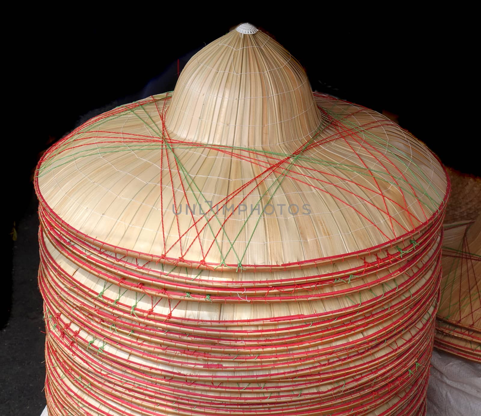 Handmade hats made from bamboo are on sale at an outdoor market