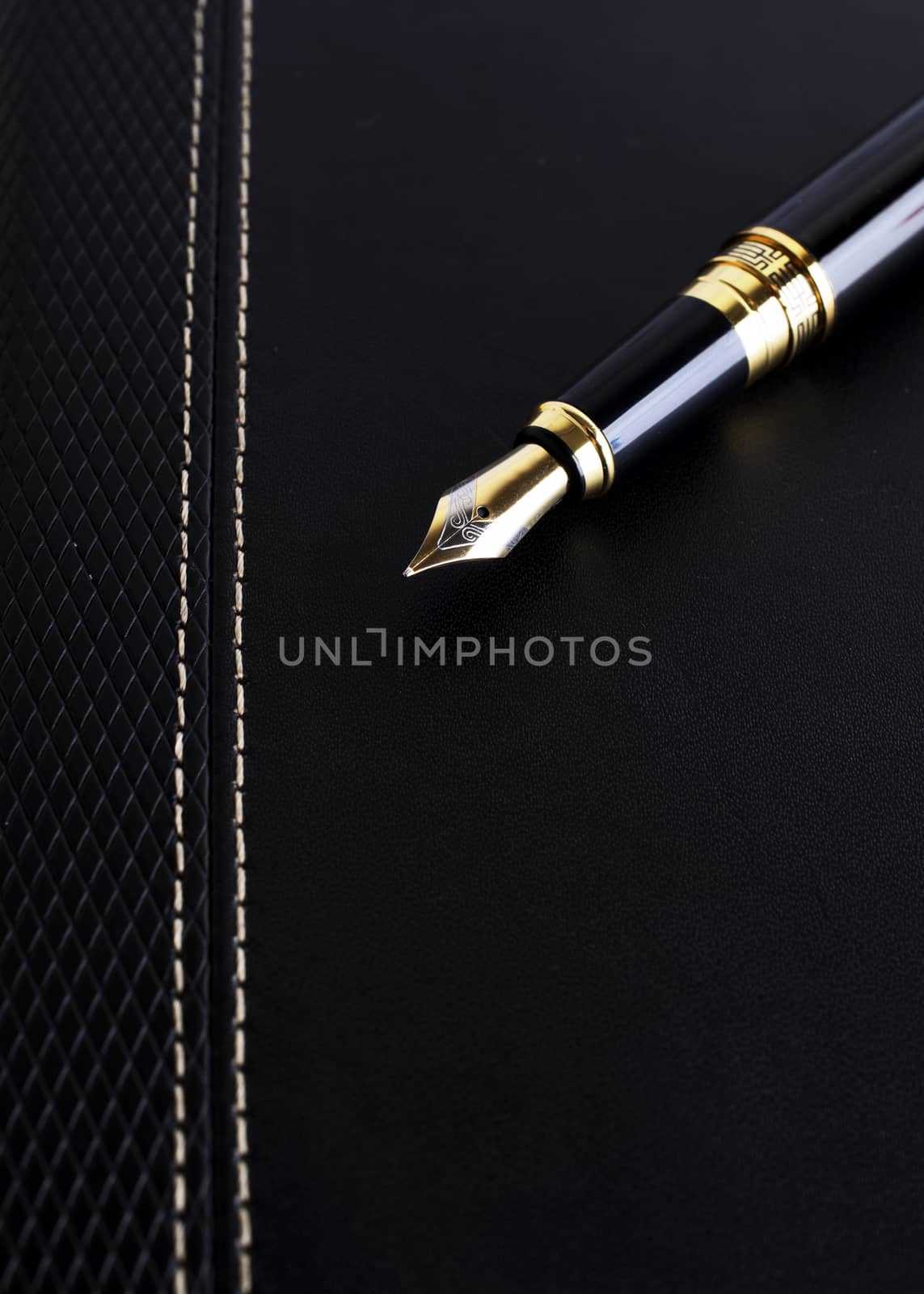 Close up of Fountain pen on leather cover book for Business concept