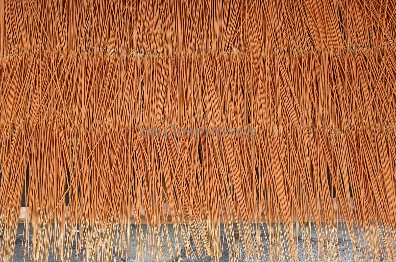 A store for religious artifacts dries incense sticks in the sun