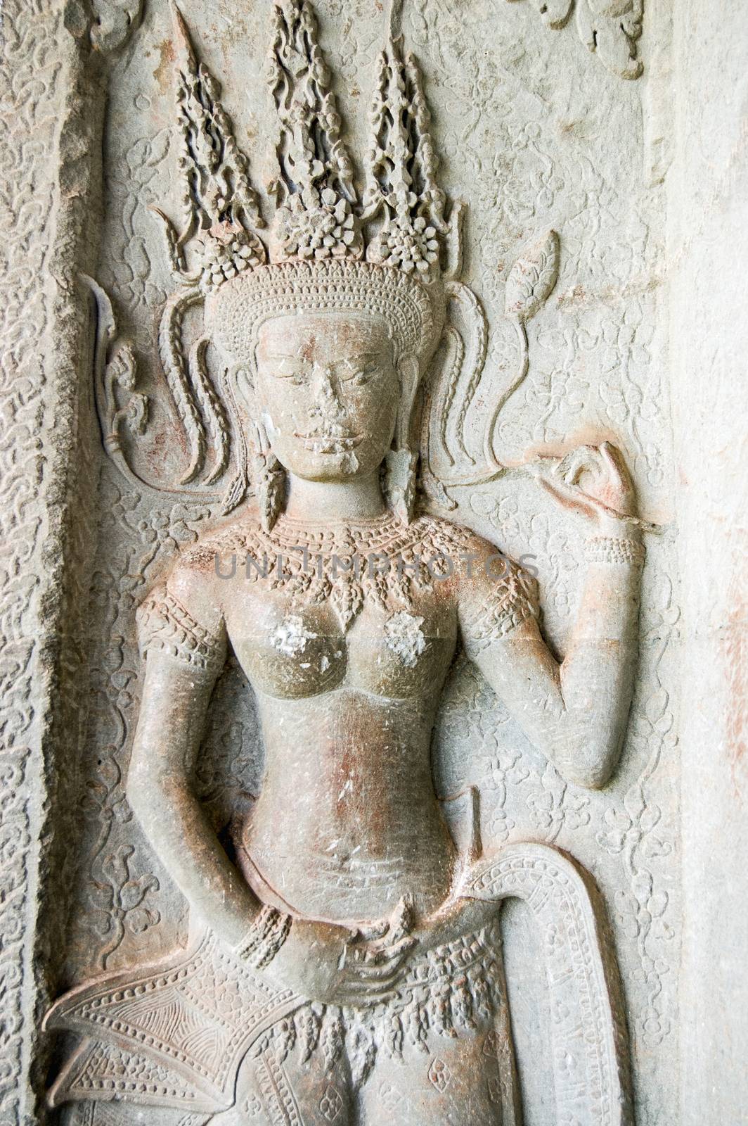 Sculpture of an Apsara dancing goddess. Interior column at Angkor Wat temple, Siem Reap, Cambodia.