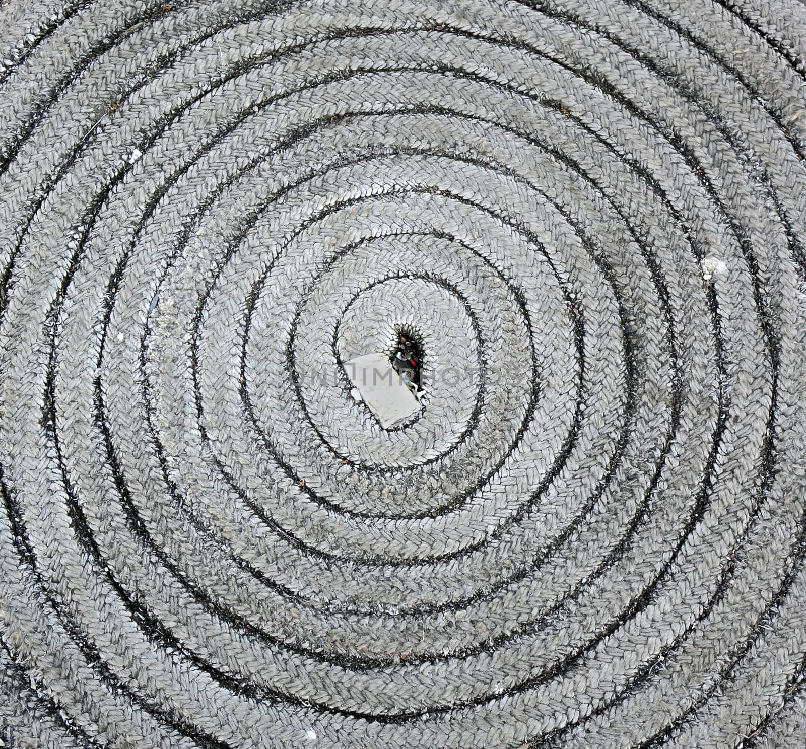 An old rope is stored in a coil shape