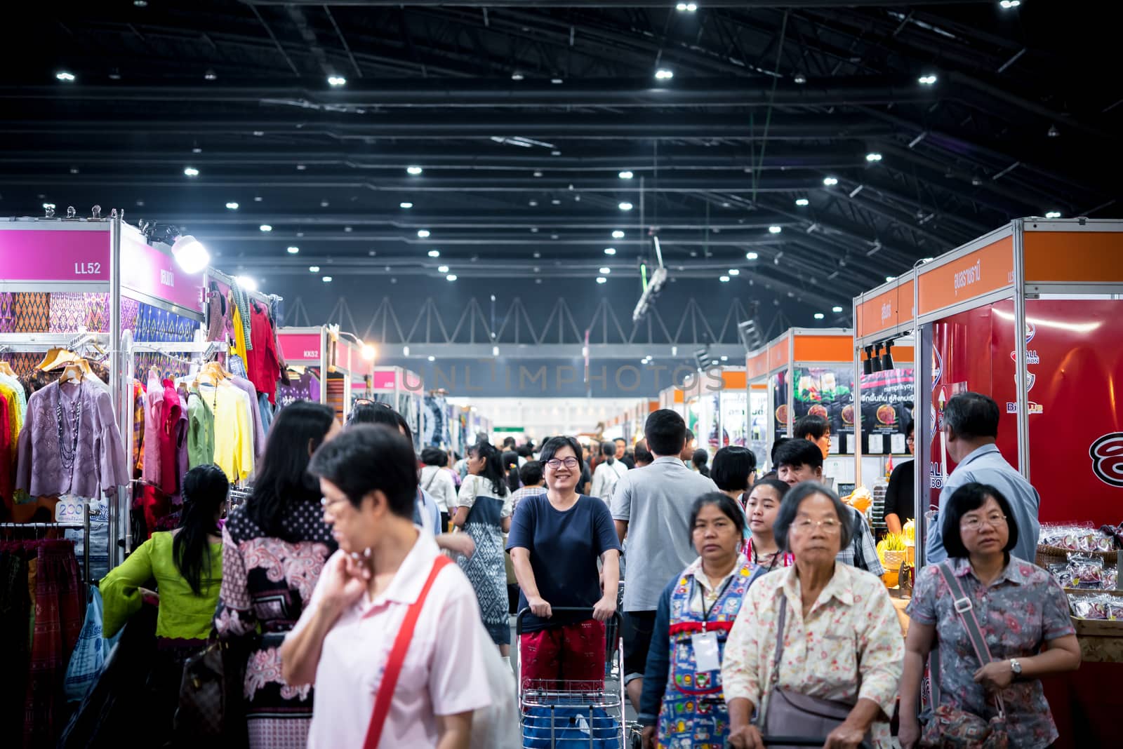 Bangkok, Thailand - December 21, 2019 : Unidentified asian woman feeling happy when her purchase a goods product in shopping cart in department store or exhibit hall expo OTOP