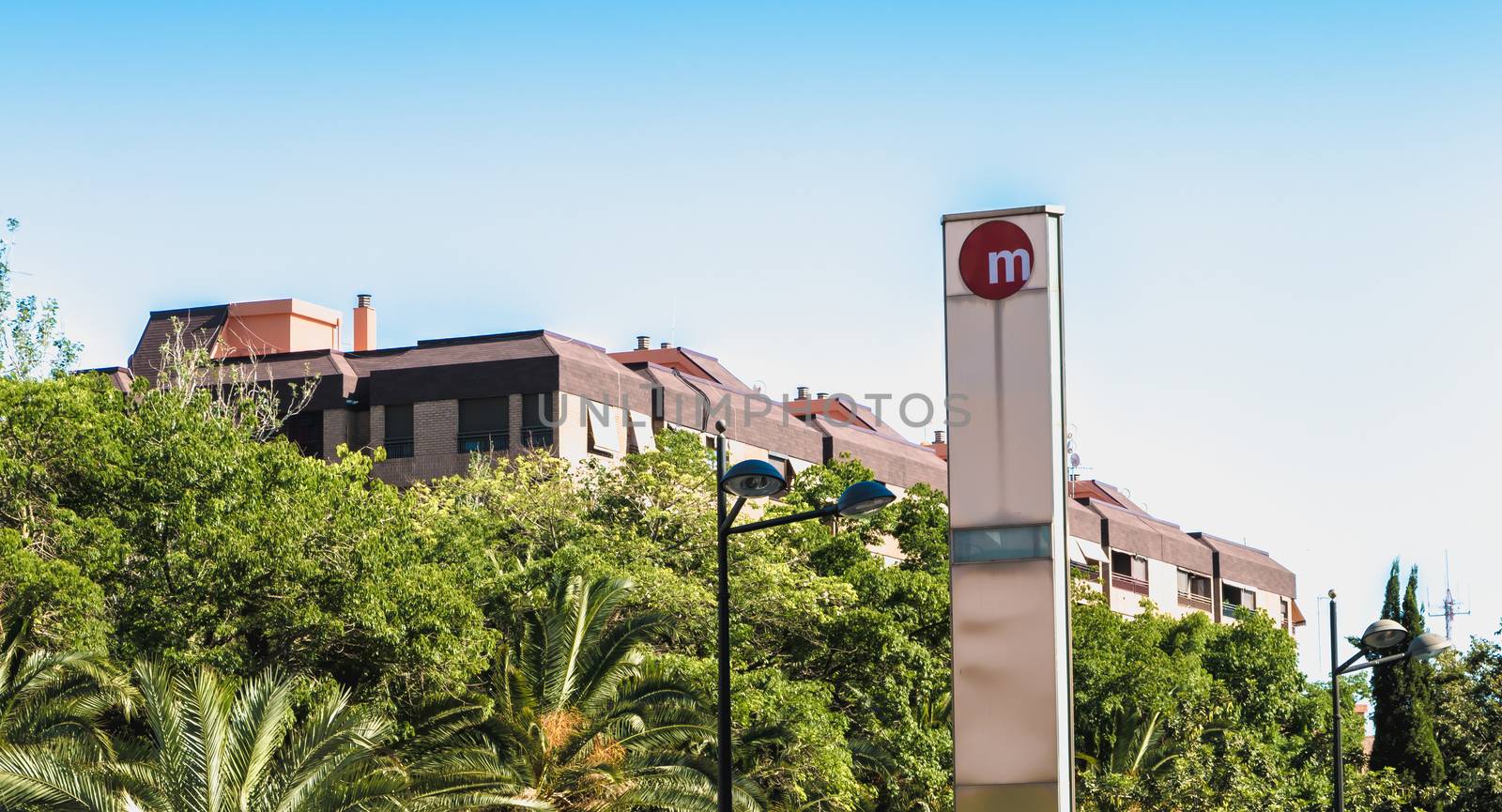 Valencia, Spain - June 18, 2017: sign indicating the entrance to a metro station in the city center on a summer day