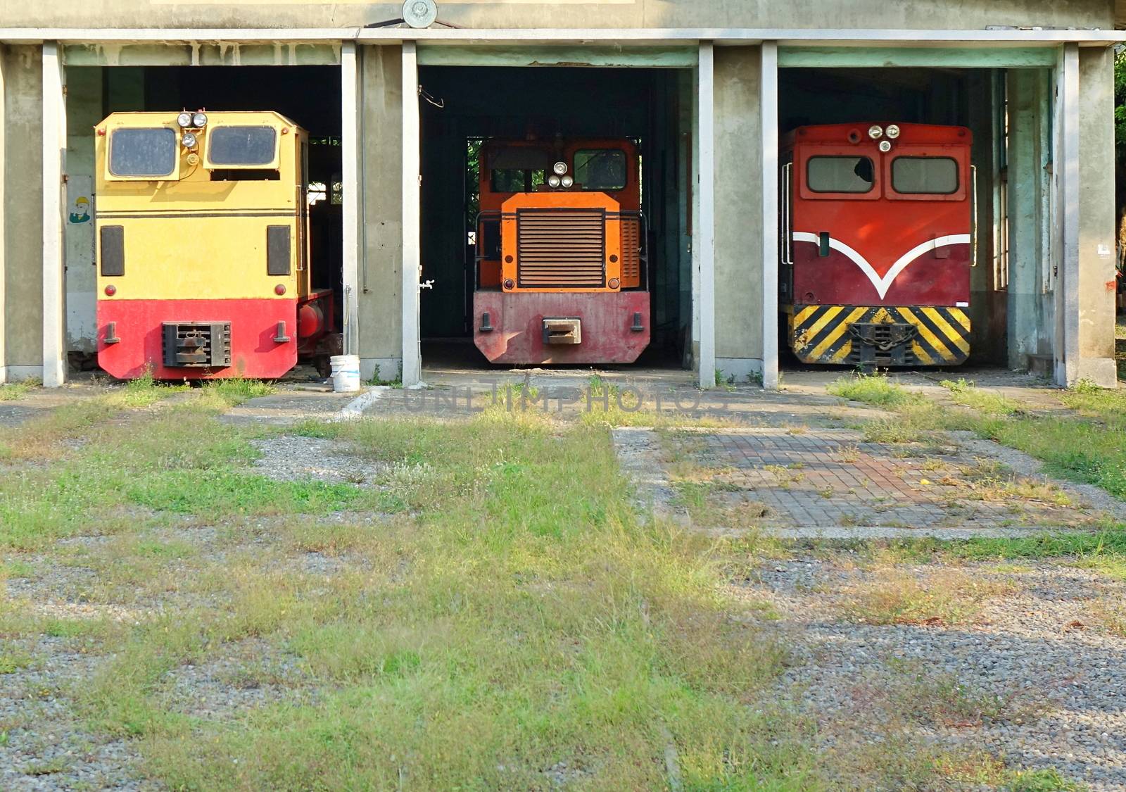 Vintage diesel powered train engines in an old shed

