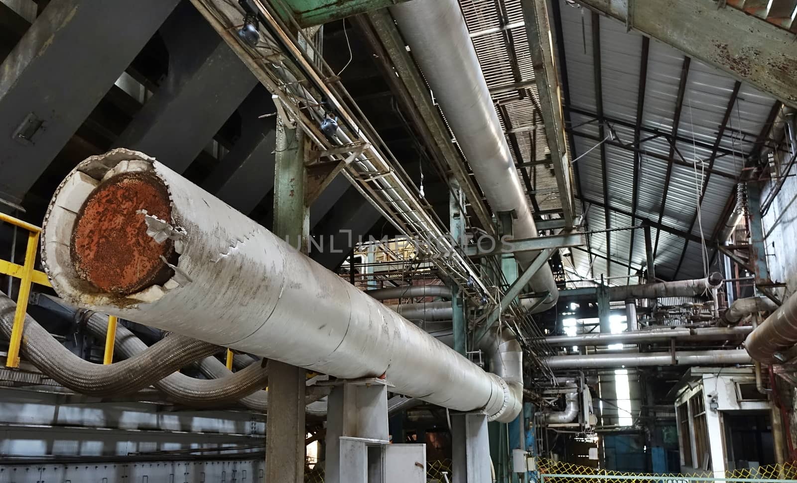 Abandoned factory with large pipes and tubes