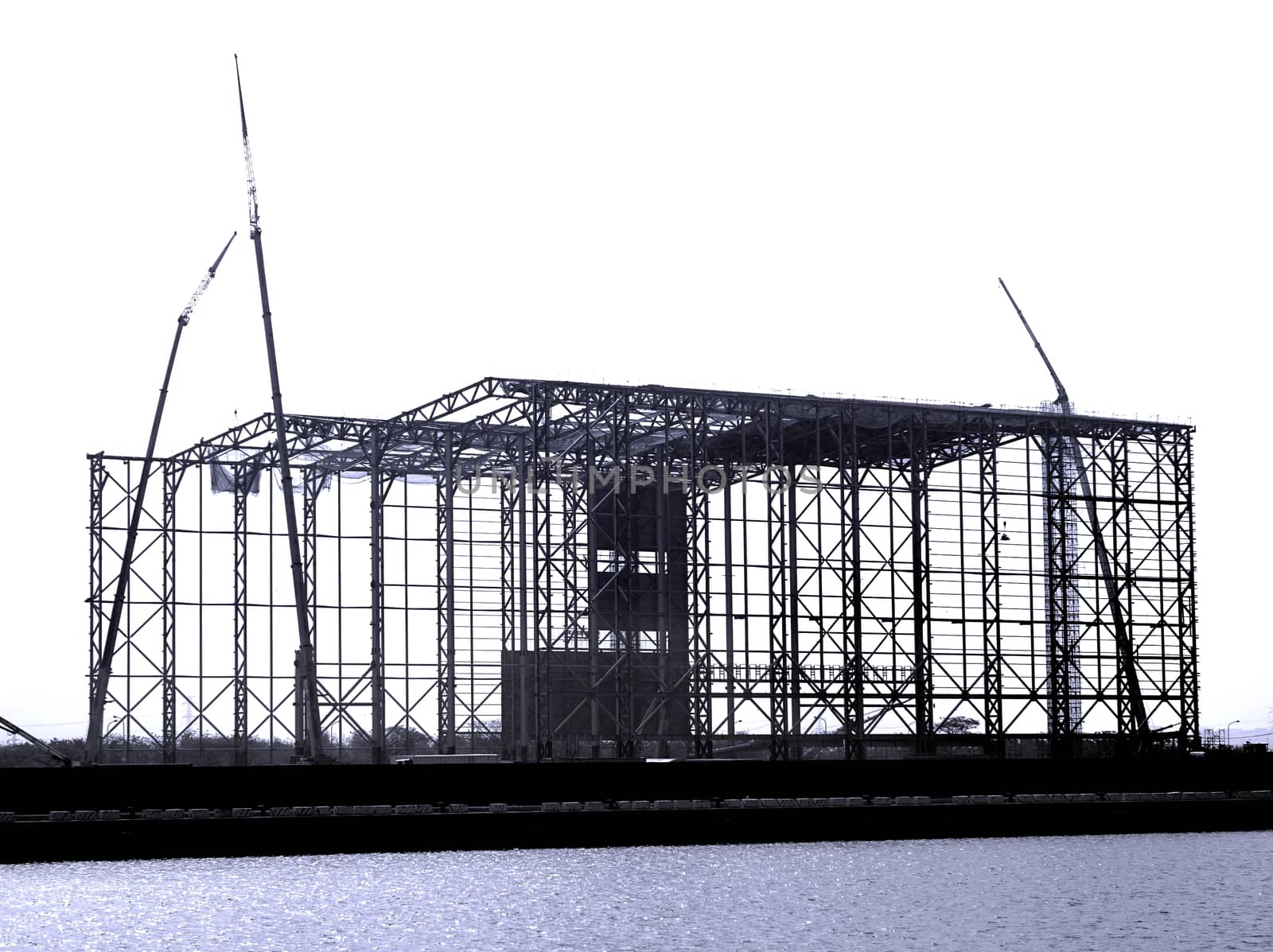 Monochrome image of a large steel structure construction
