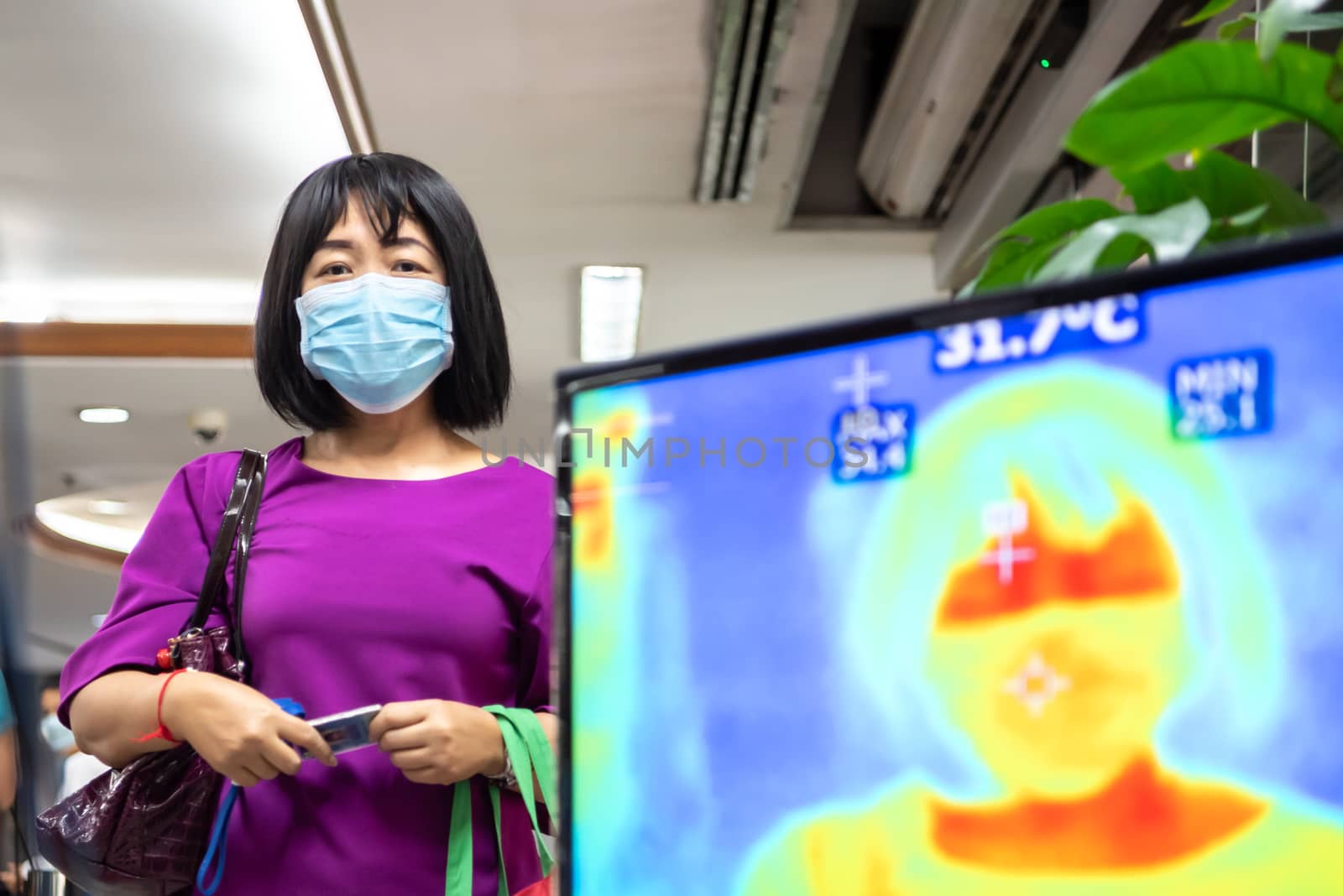 Bangkok, Thailand - March 18, 2020 : Unidentified people waiting body temperature check to access building for against epidemic flu covid19 or corona virus by thermoscan or infrared thermal camera