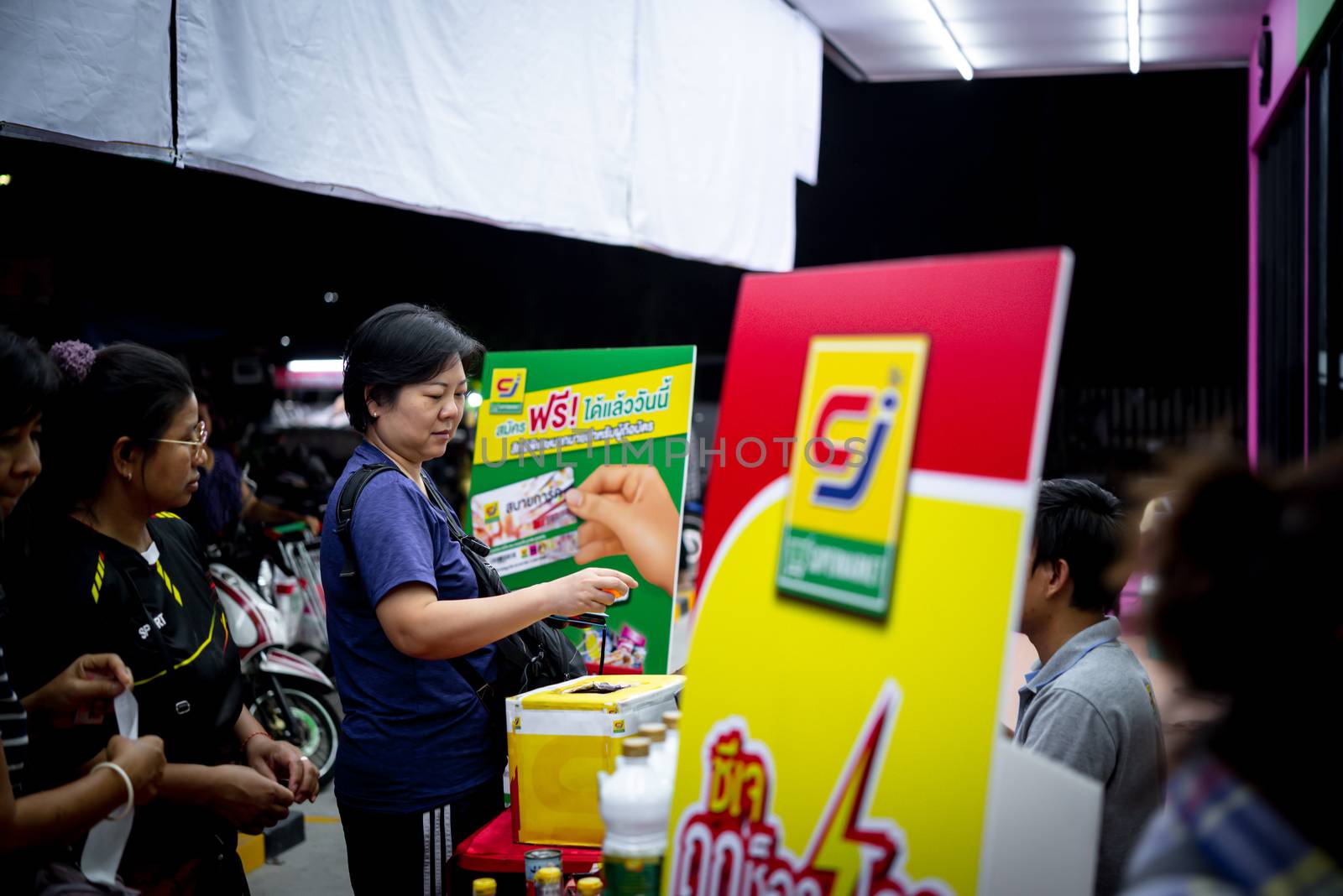 Bangkok, Thailand - November 16, 2019 : Unidentified asian woman feeling happy when her purchase a product and QR code scan by mobile phone in department store or exhibit hall expo
