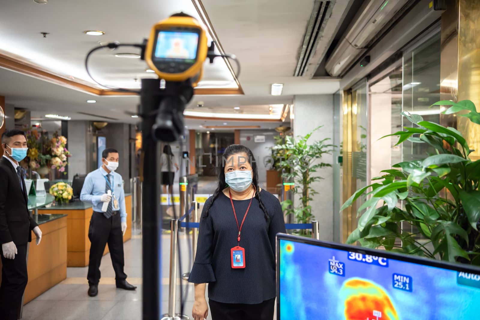 Bangkok, Thailand - March 18, 2020 : Unidentified people waiting body temperature check to access building for against epidemic flu covid19 or corona virus by thermoscan or infrared thermal camera