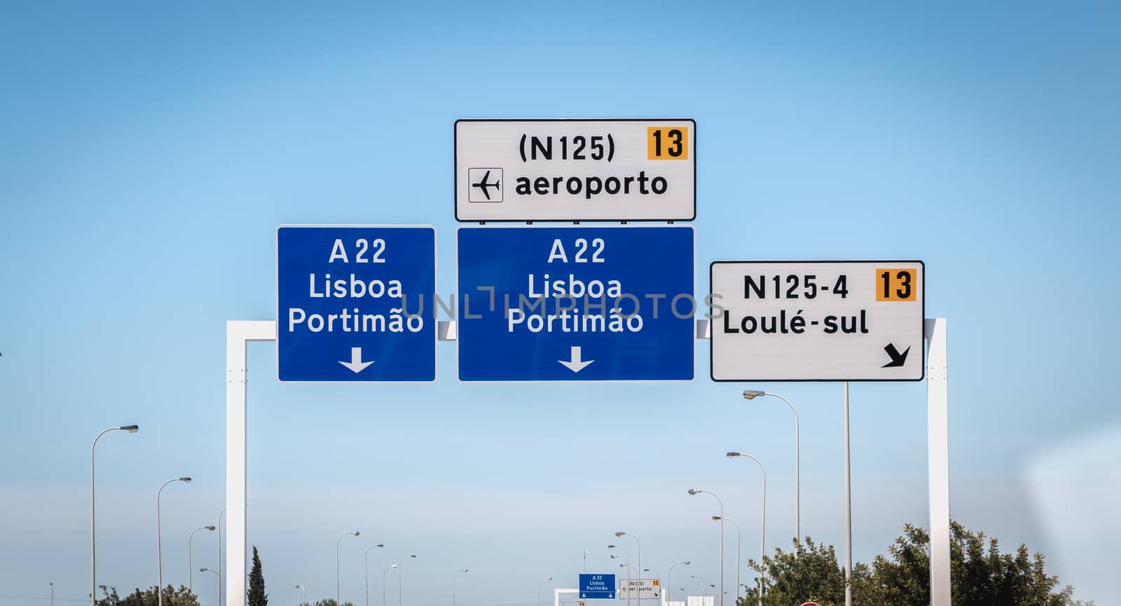 blue road sign on A22 highway indicating the direction of Lisbon by AtlanticEUROSTOXX