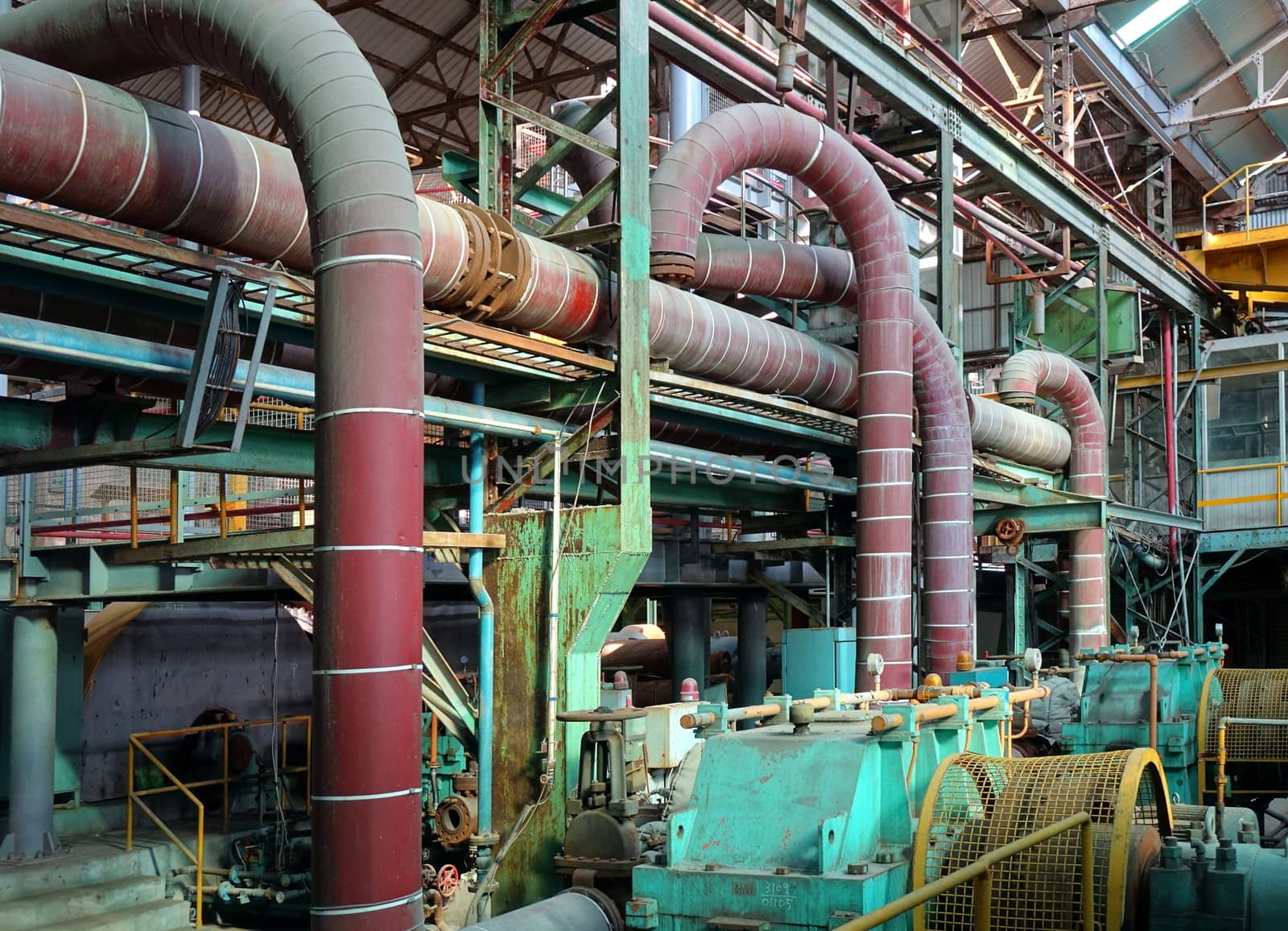 An abandoned old factory with large industrial equipment
