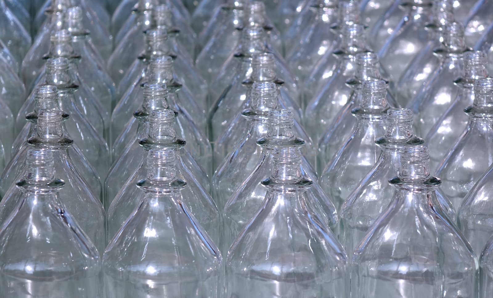 Rows of empty glass bottles with no caps