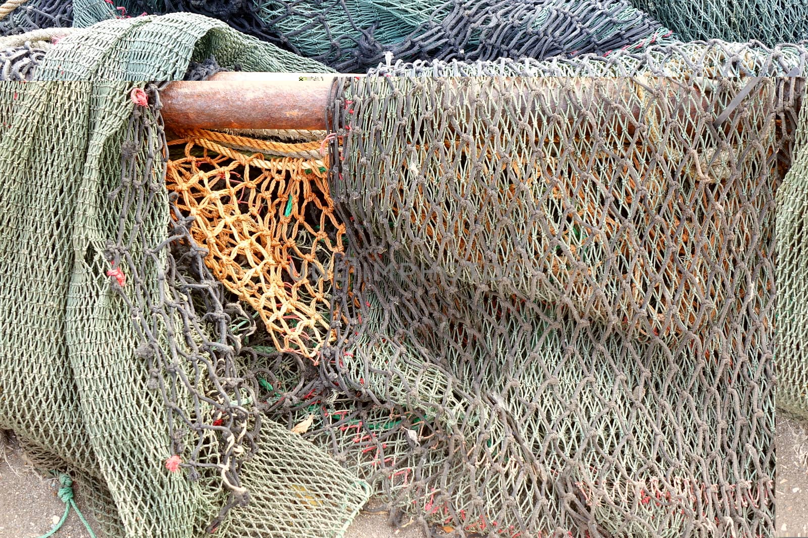 A bunch of old broken fishing nets are lying on the docks
