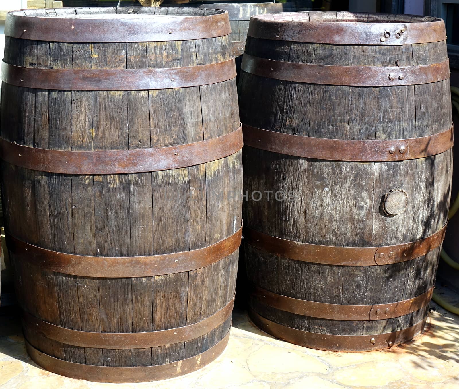 Vintage wooden oak barrels with rusting hoops