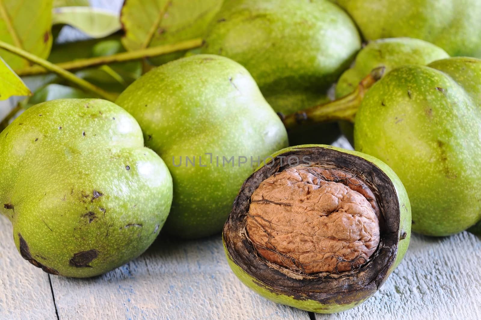 Walnuts on wooden table in the kitchen.