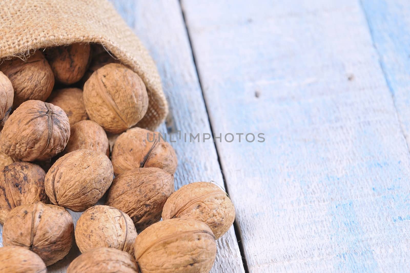 Walnuts on wooden table in the kitchen.