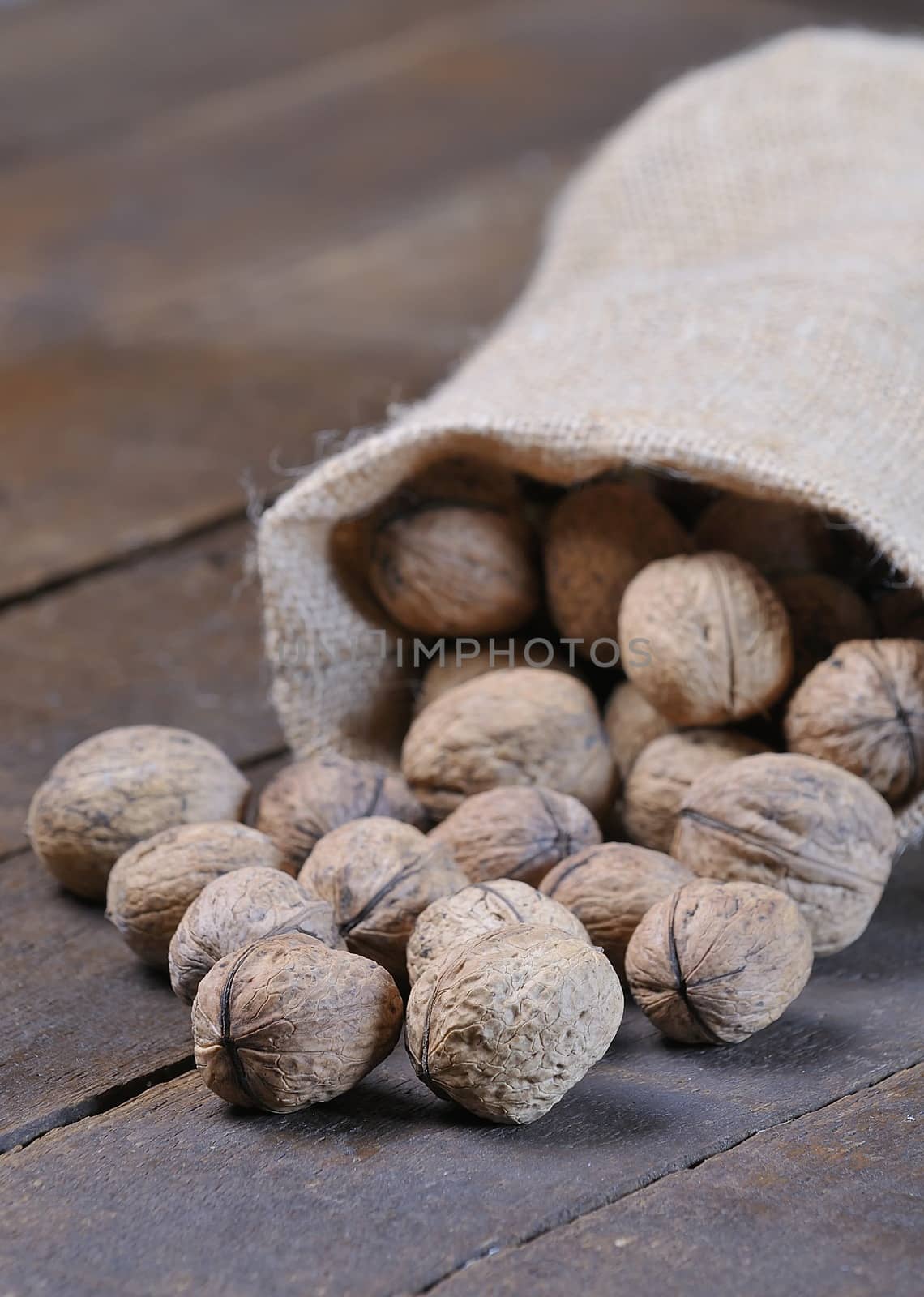 Walnuts on wooden table in the kitchen.