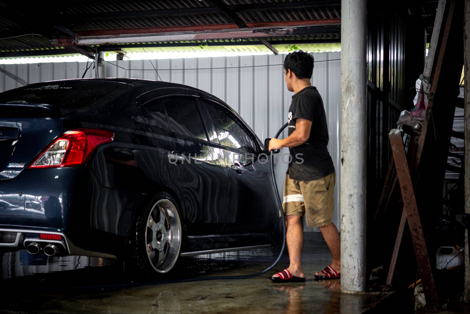 Bangkok, Thailand - November 9, 2019 : Unidentified car care staff cleaning (clean, wash, polish and wax) the car (Car detailing) at car care shop in Bangkok Thailand