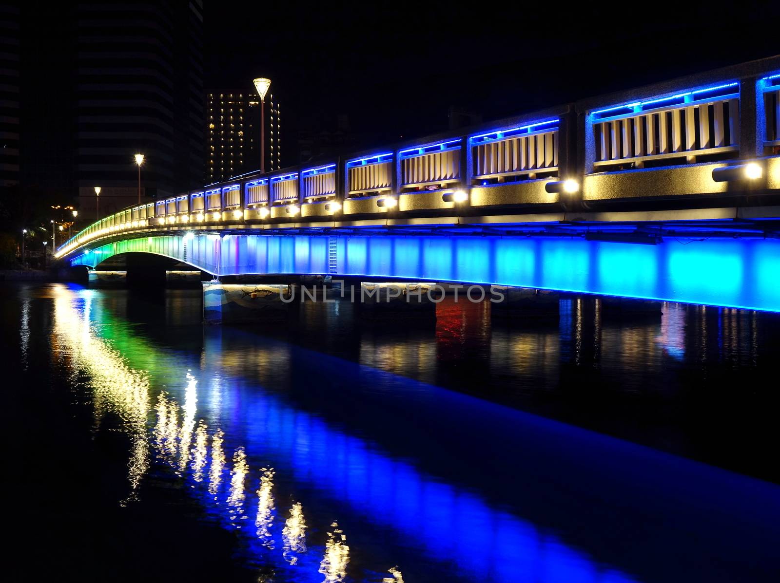 Evening view of the Love River with one of its illuminated bridges 