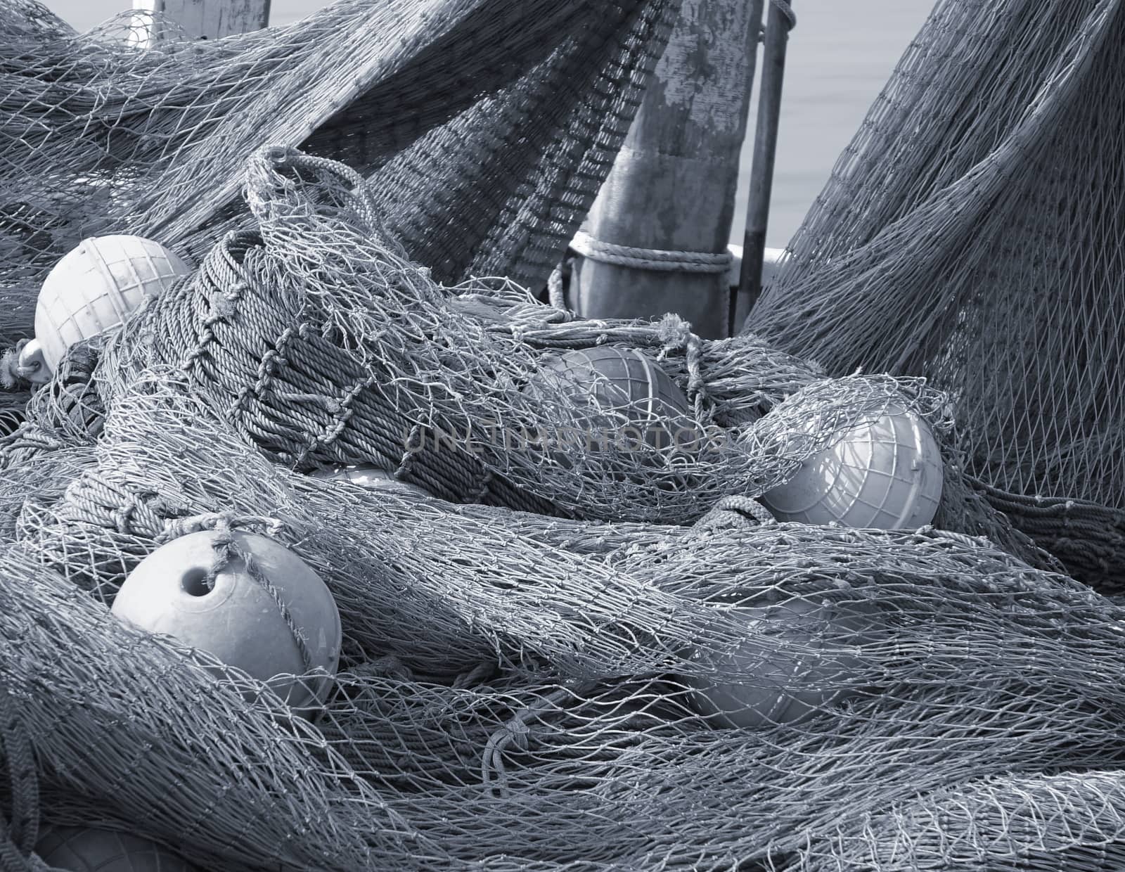 A pile of old fishing nets with hollow round plastic floats