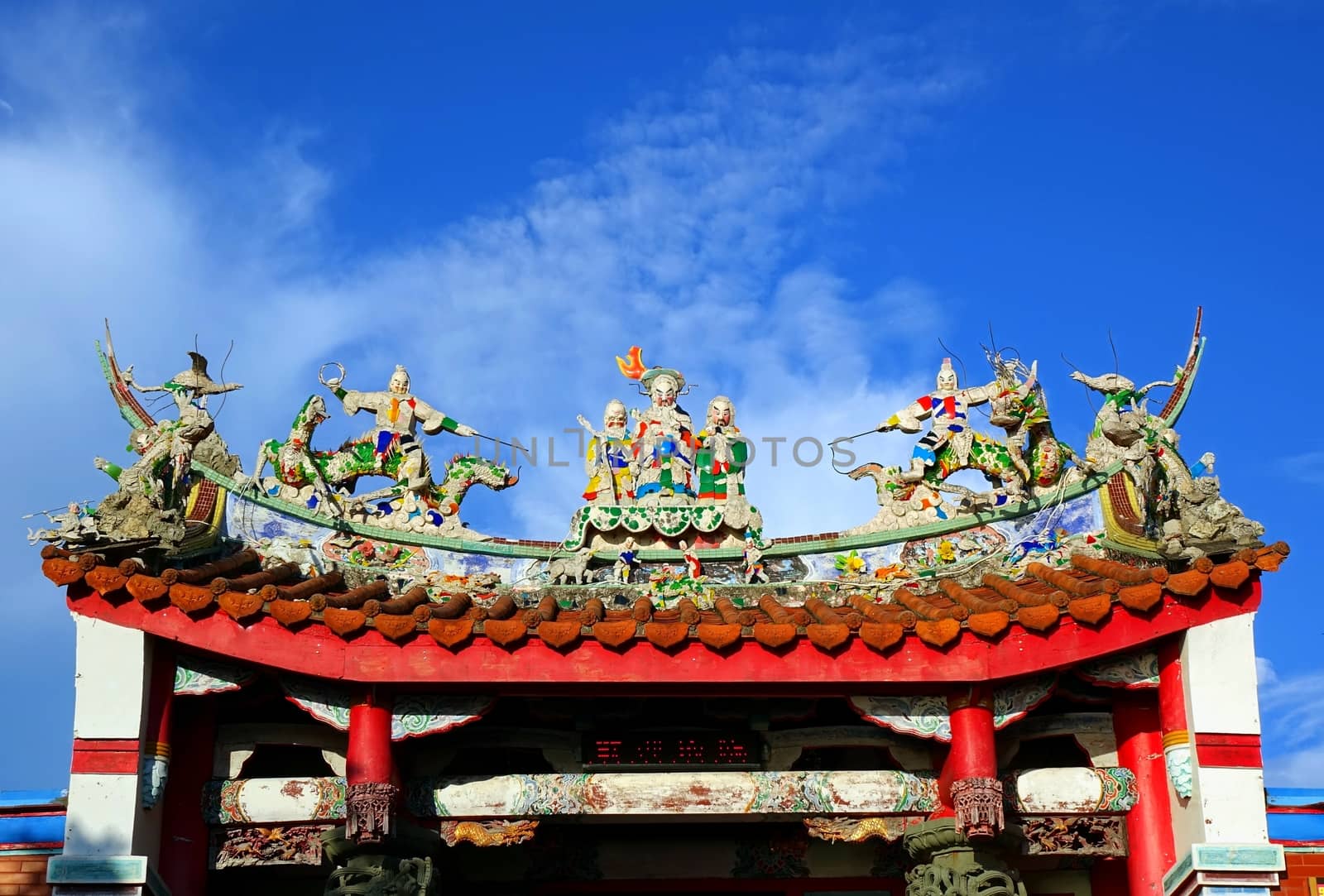 A Chinese temple with colorful decorations of mythological warriors