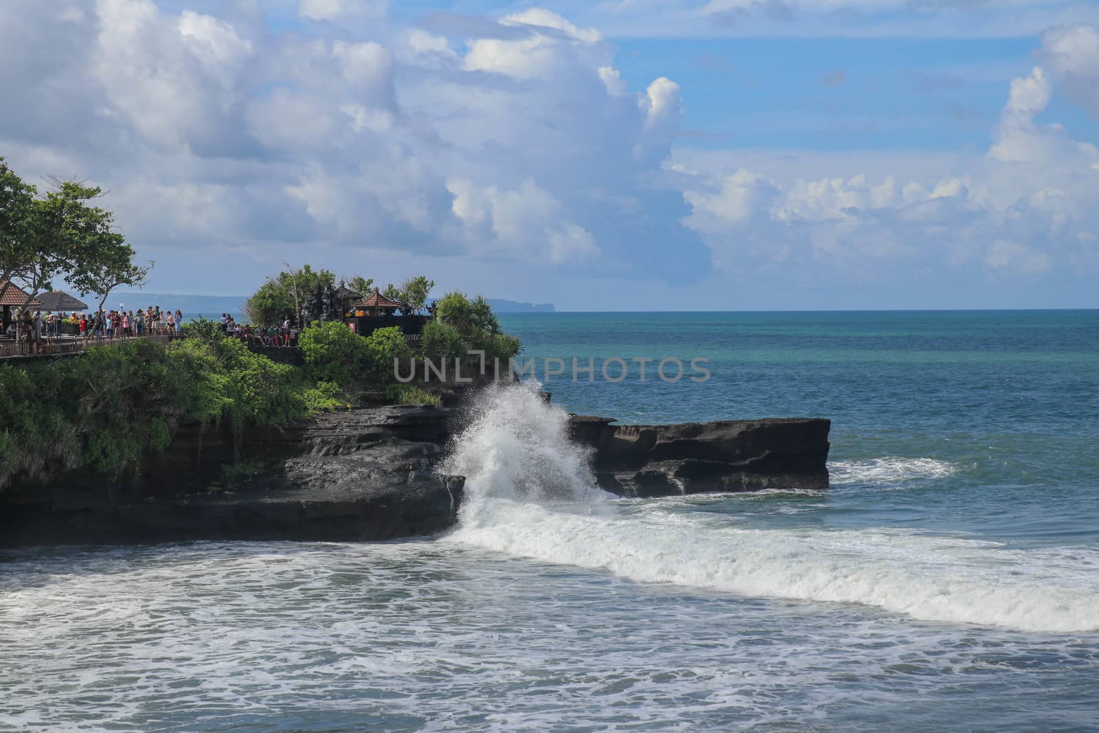 Batu Bolong beach which has an tourism attraction spot, close to Tanah Lot temple on the top of the hill. Small bay and sandy beach adjacent to Pura Batu Bolong in Bali, Indonesia. Natural background.