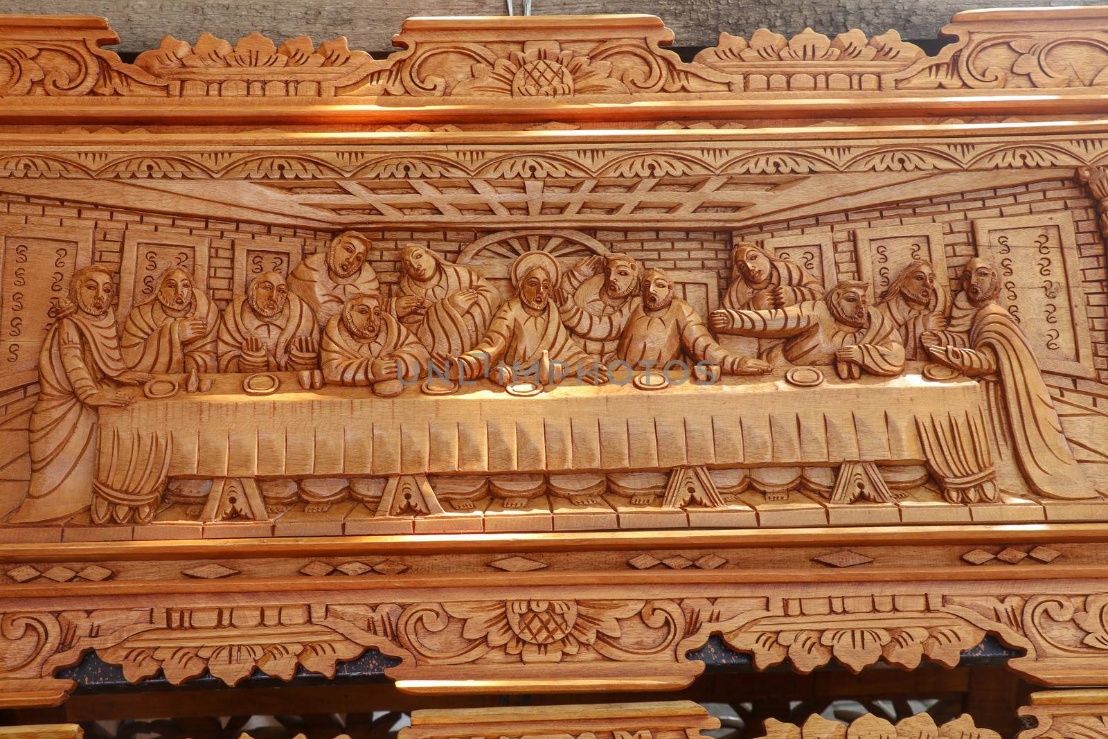 Scene of the last dinner carved in wood. Pattern of Supper carved on wood. Jesus shared with Apostles in Jerusalem before crucifixion wood carving. Wood carving decoration depicting stories from Bible