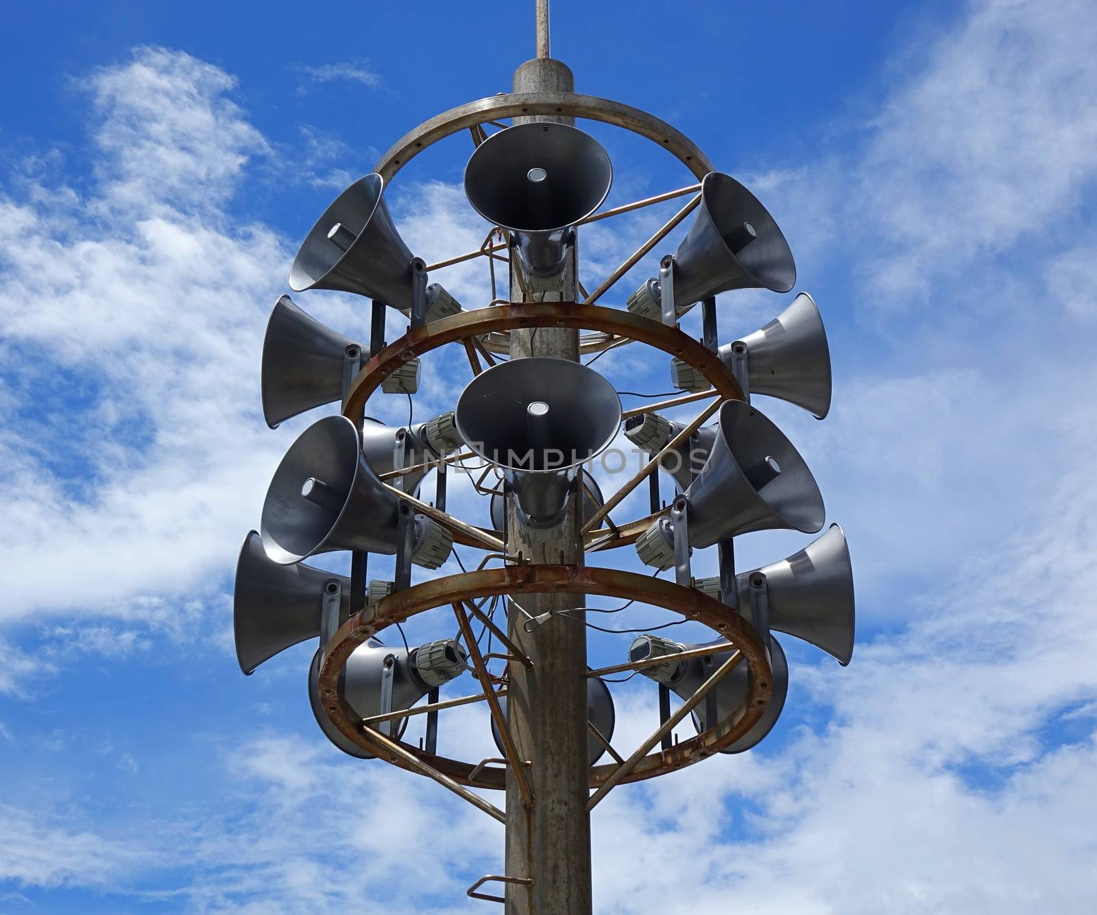 A large outdoor public address system with stacks of megaphones