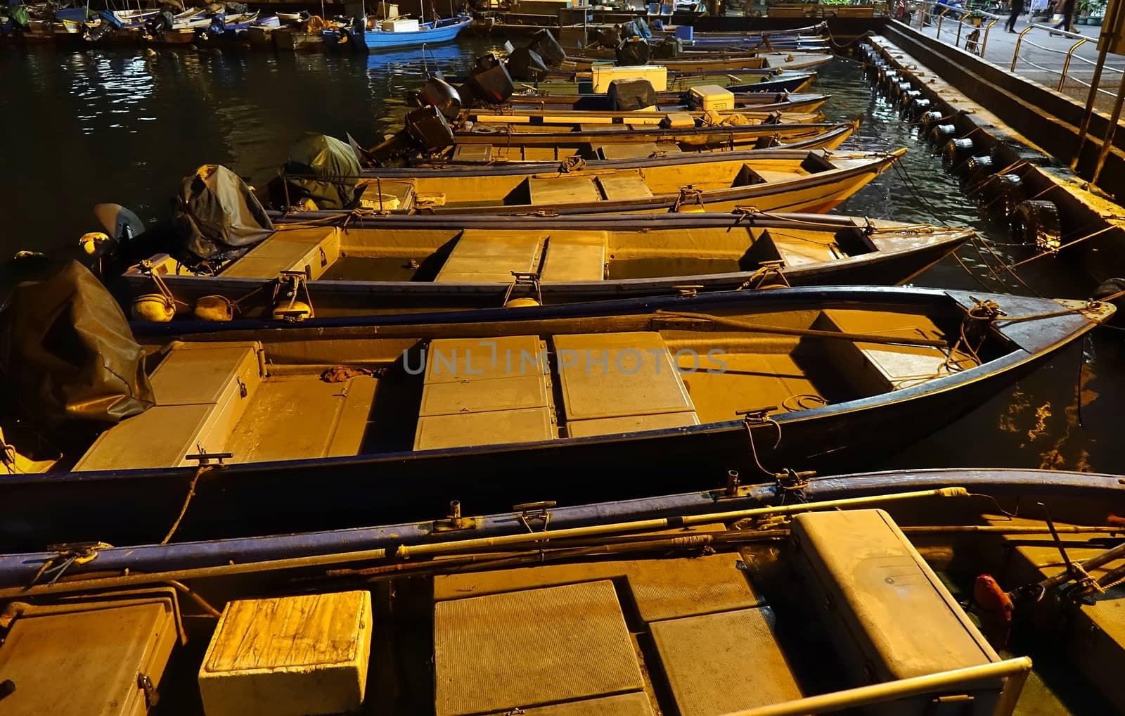 Small boats in a small fishing harbor at night