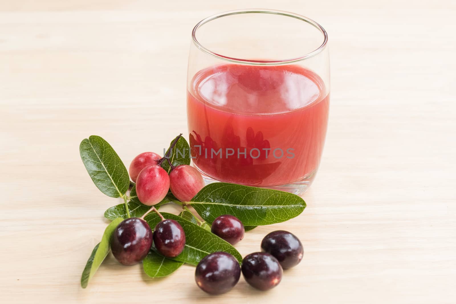 fresh Carissa carandas glass of juice with Carissa carandas fruits and Healthy drinks concept
