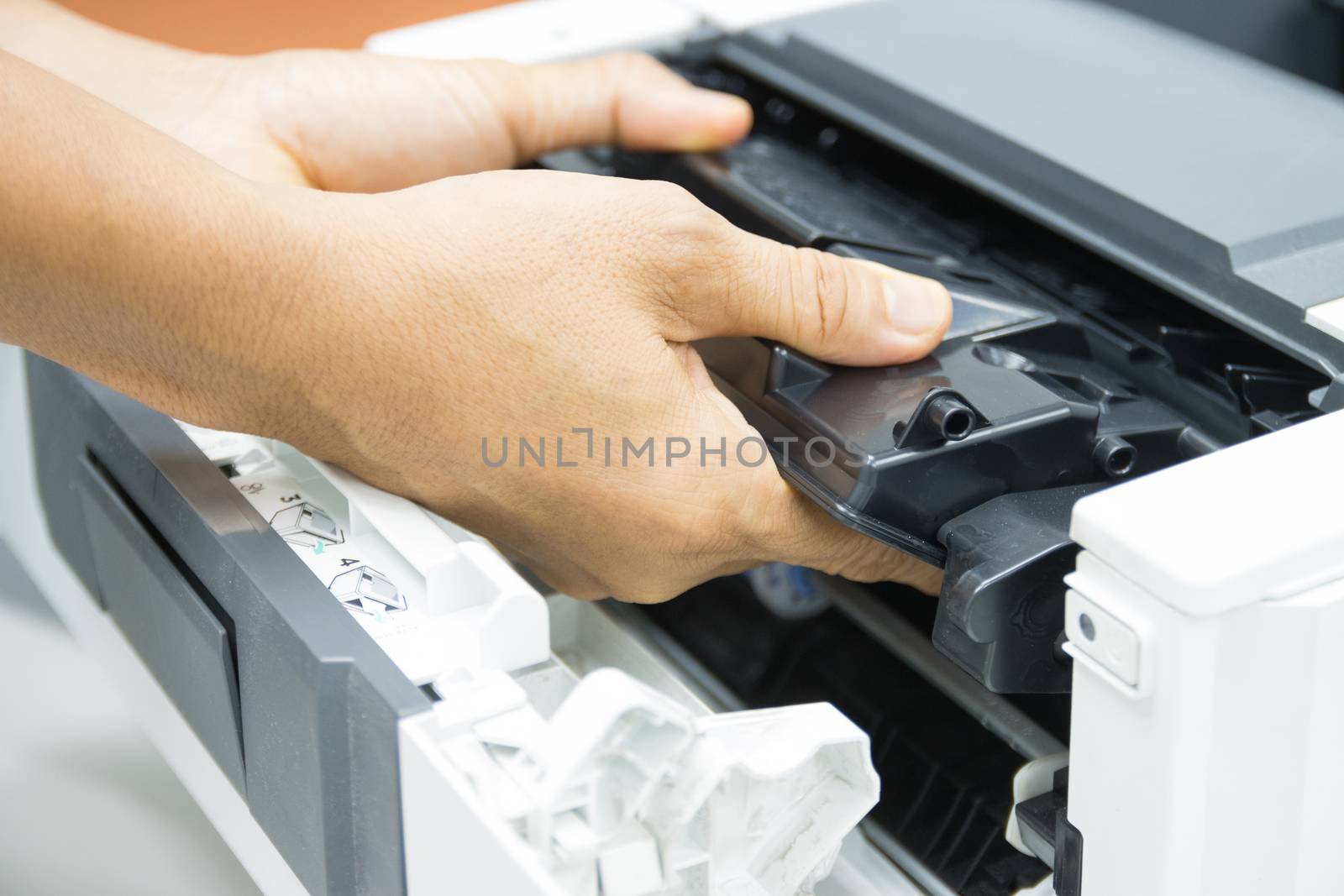 Technicians replacing toner in laser printer concept office supplies repair