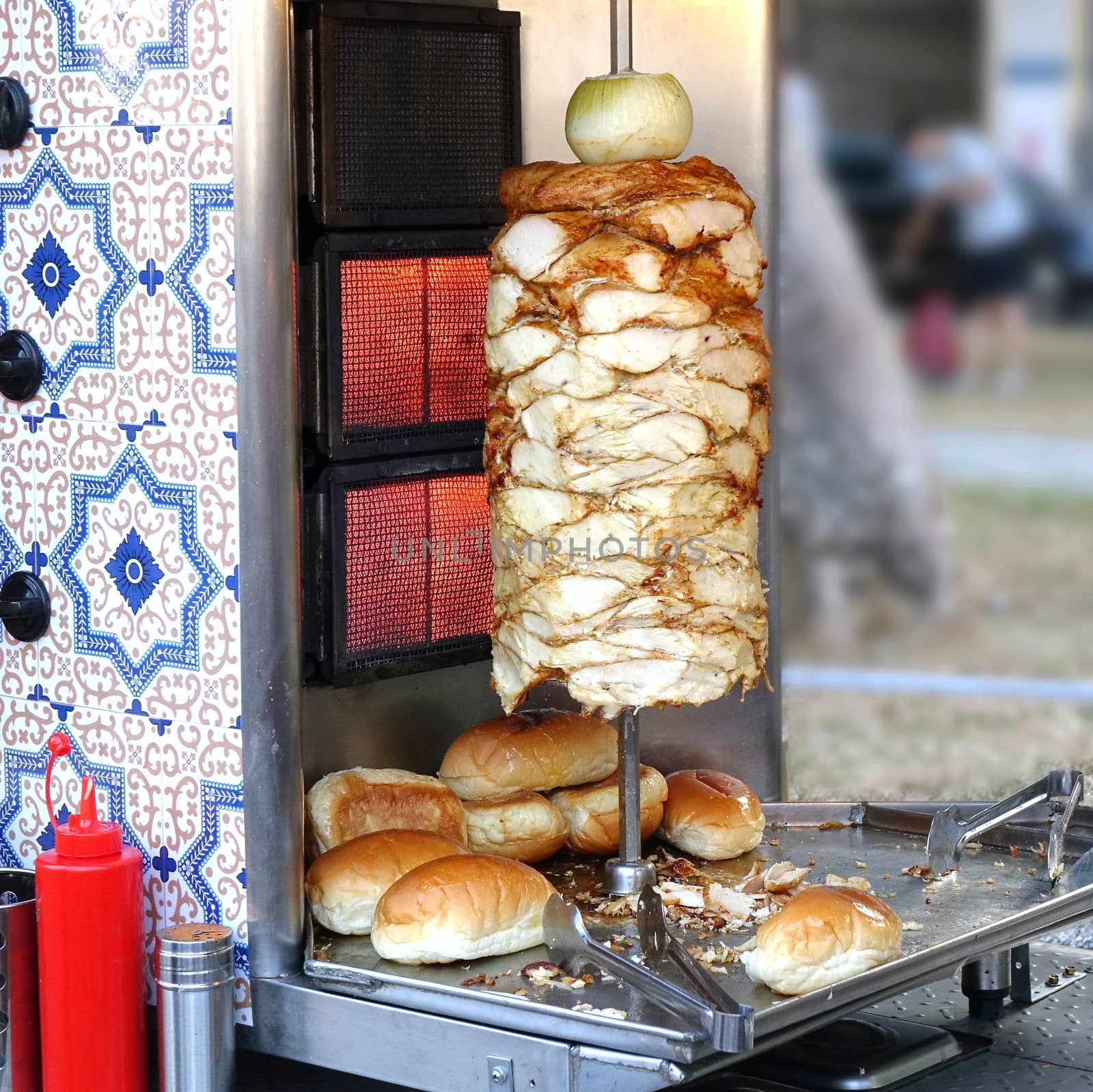 A stall selling shawarma meat and bread buns